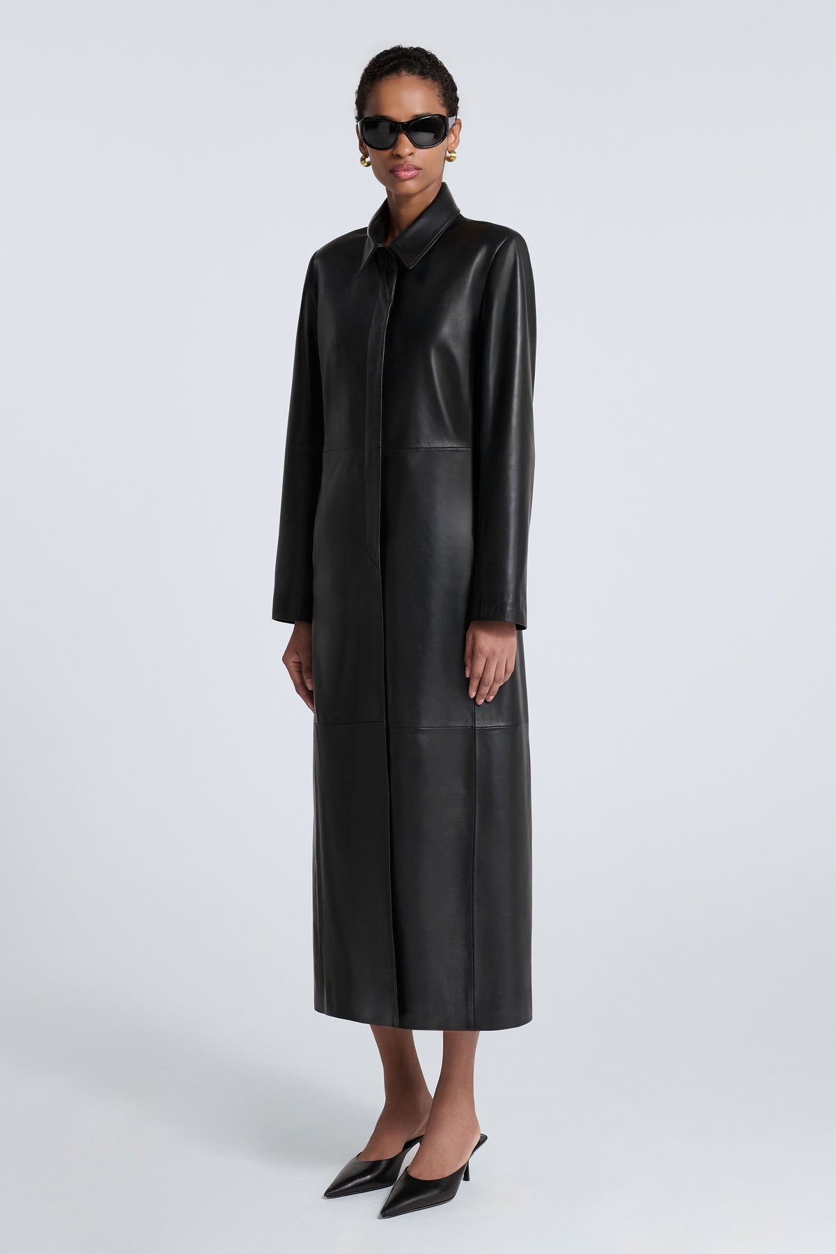 Model is Wearing Nour Hammour Gotham 90s Longline Leather Coat - Three Quarters 