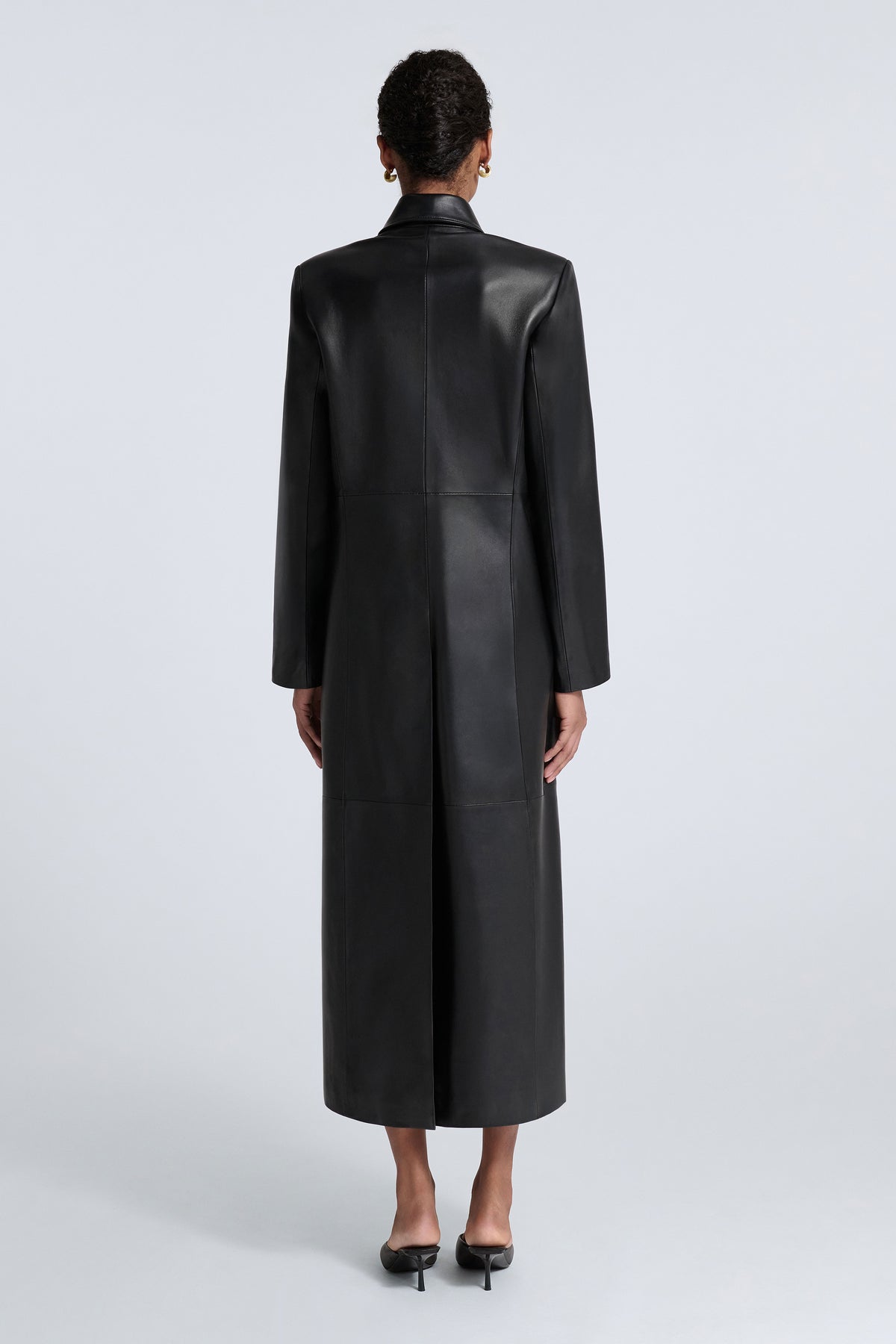 Model is Wearing Nour Hammour Gotham 90s Longline Leather Coat Black - Back