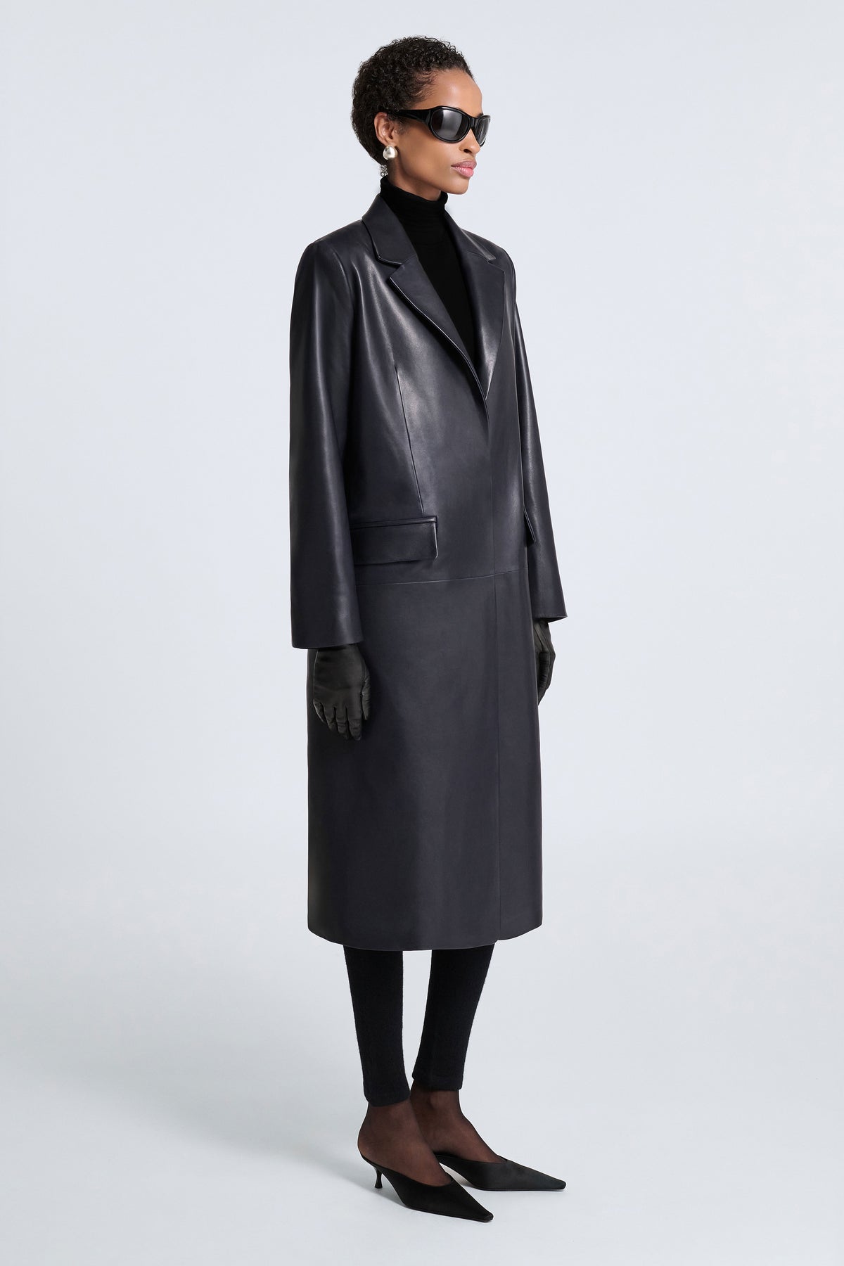 Model is Wearing Nour Hammour Isaline Leather City Overcoat Bleu Minuit - Three Quarters