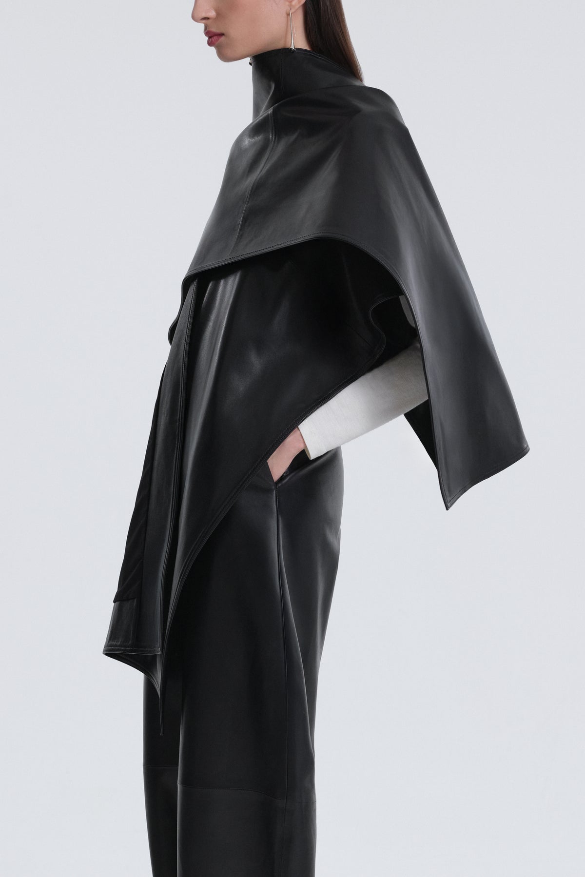 Model is Wearing Nour Hammour Edra Sleek Leather Cape Black - Three Quarters 