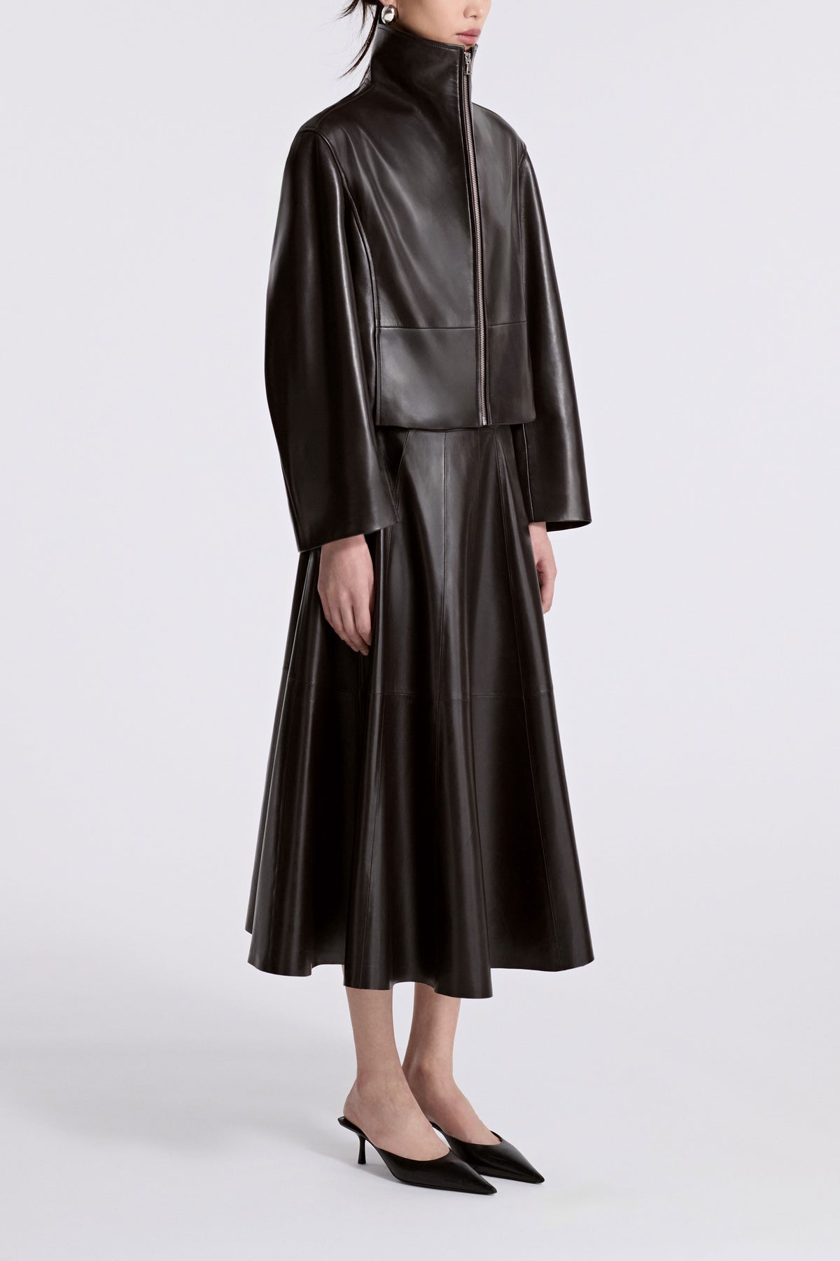 Model is Wearing Nour Hammour Etienne Funnel Neck Leather Jacket Dark Brown - Three Quarters 