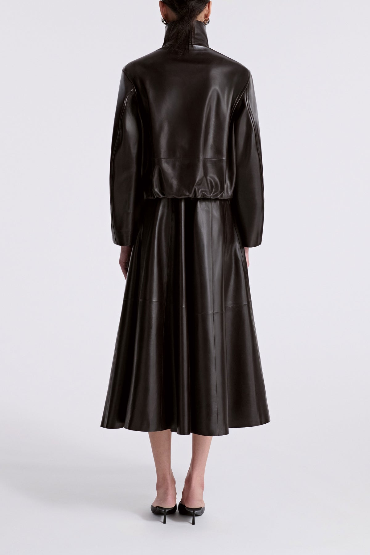 Model is Wearing Nour Hammour Etienne Funnel Neck Leather Jacket Dark Brown - Back 