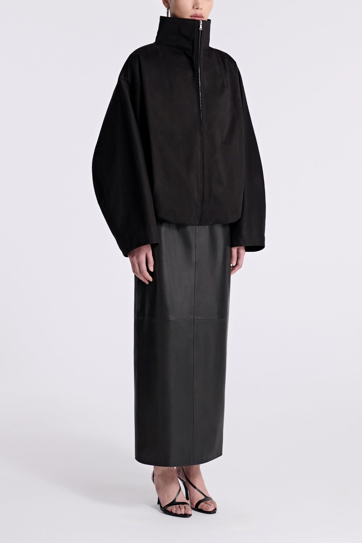 Model is Wearing Nour Hammour Francois Funnel Neck Cotton Bomber Black - Three Quarters 