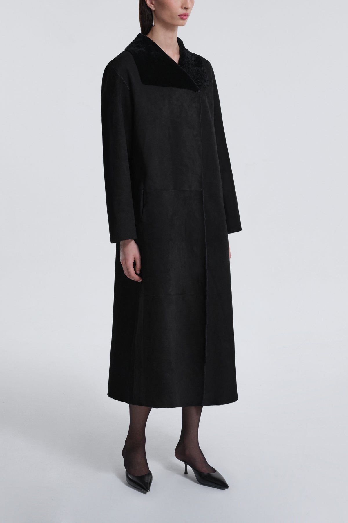 Model is Wearing Nour Hammour Birthday Coat Draped Merinos Coat Black - Three Quarters 