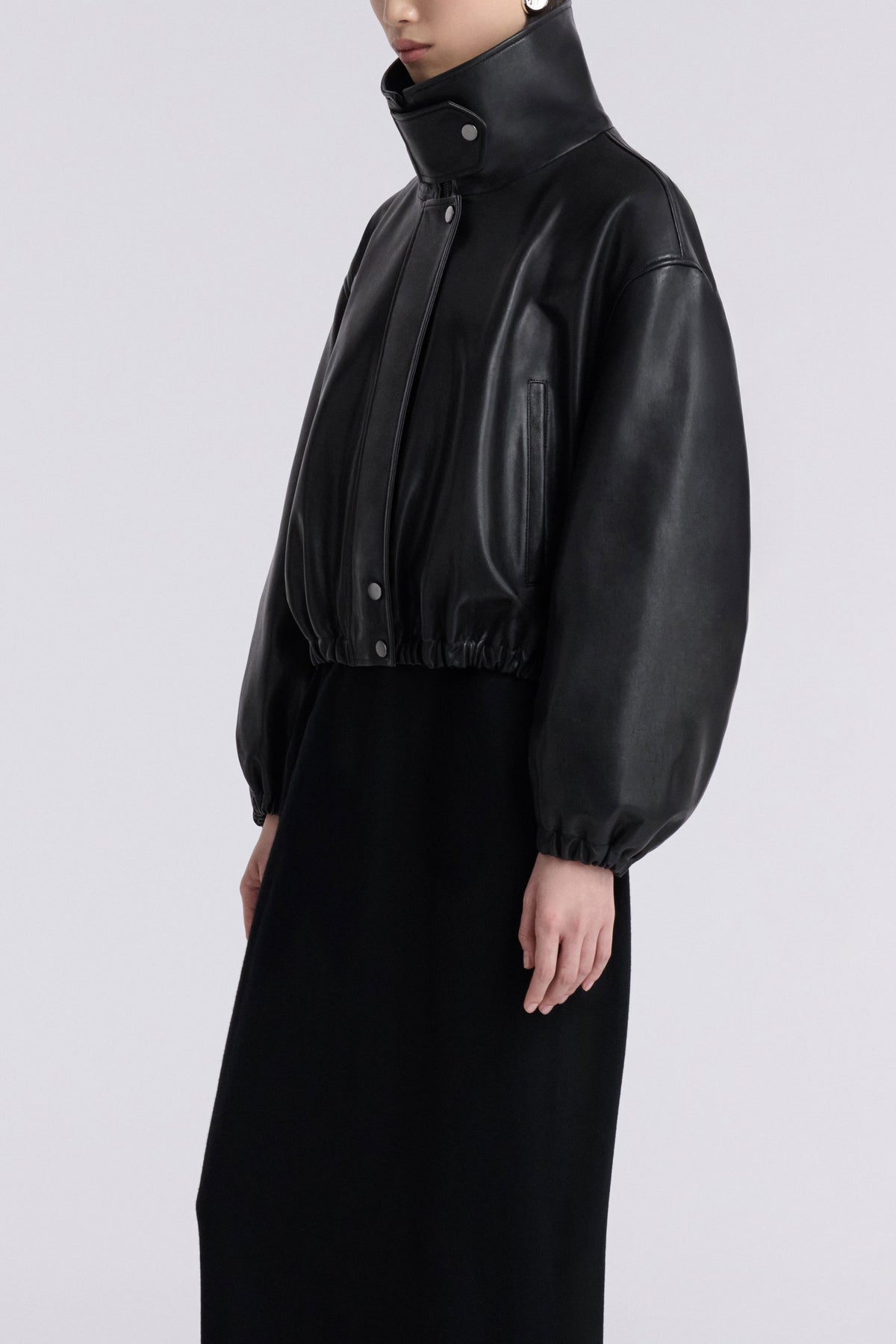Model is Wearing Nour Hammour Pia Cropped Relaxed Leather Bomber Noir Classique - Three Quarters