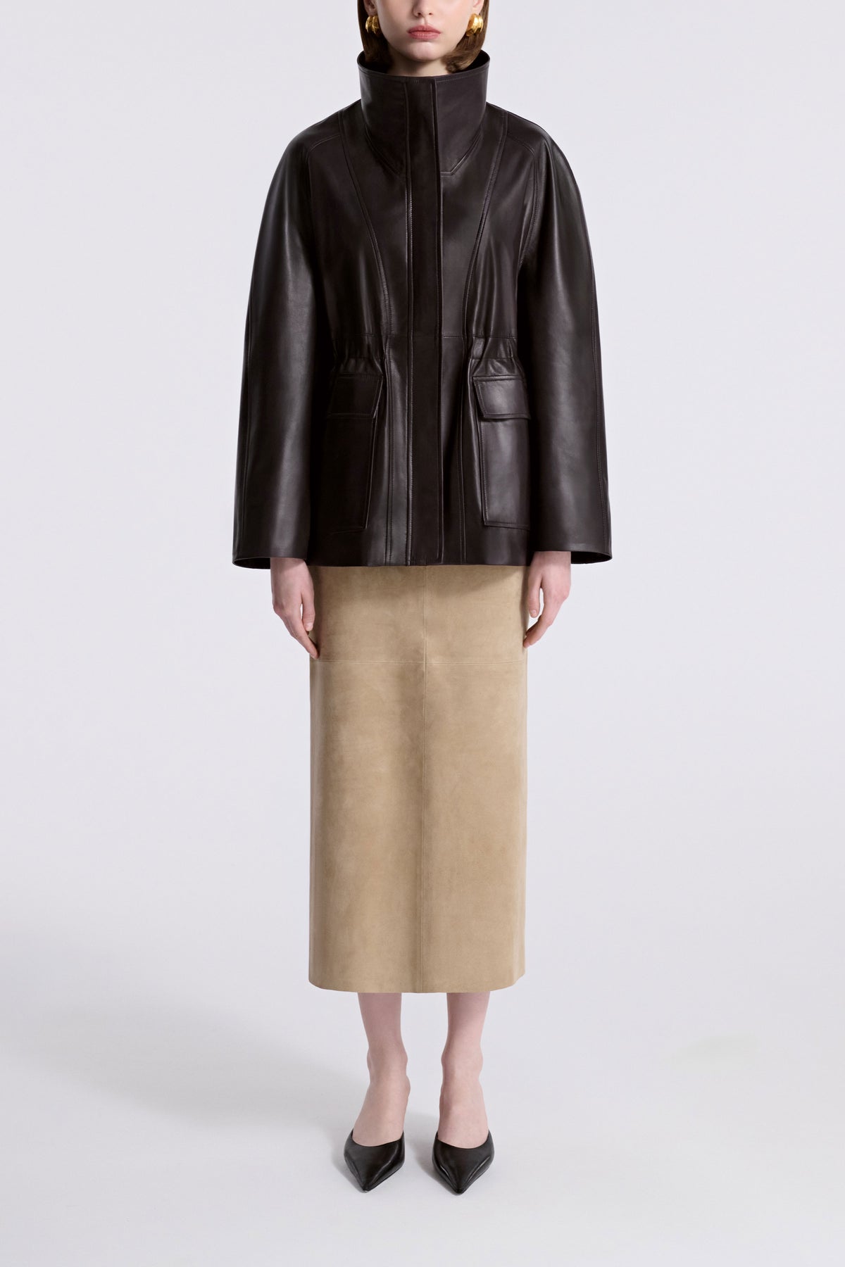 Model is Wearing Nour Hammour Quai Cinched Funnel Neck Leather Jacket Dark Brown - Front 