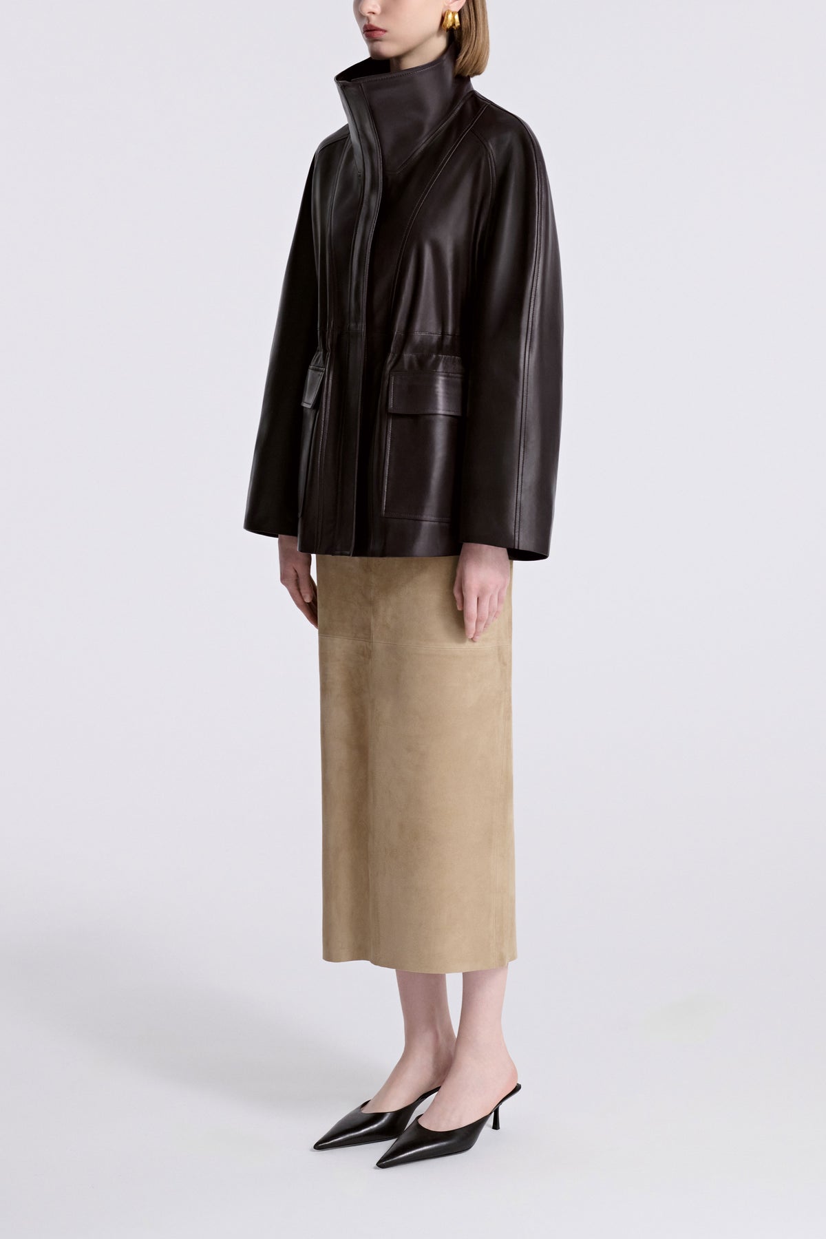 Model is Wearing Nour Hammour Quai Cinched Funnel Neck Leather Jacket Dark Brown - Three Quarters 