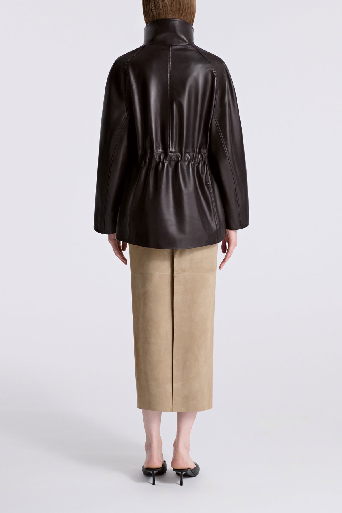 Model is Wearing Nour Hammour Quai Cinched Funnel Neck Leather Jacket Dark Brown - Back