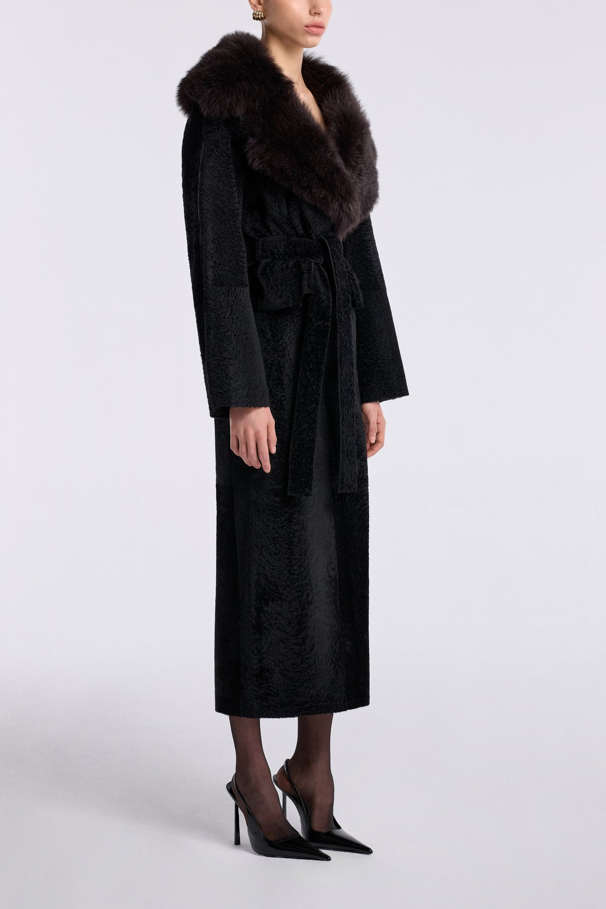 Model is wearing the Nour Hammour Renata Velvety Shearling Coat Noir Boheme - Three Quarters