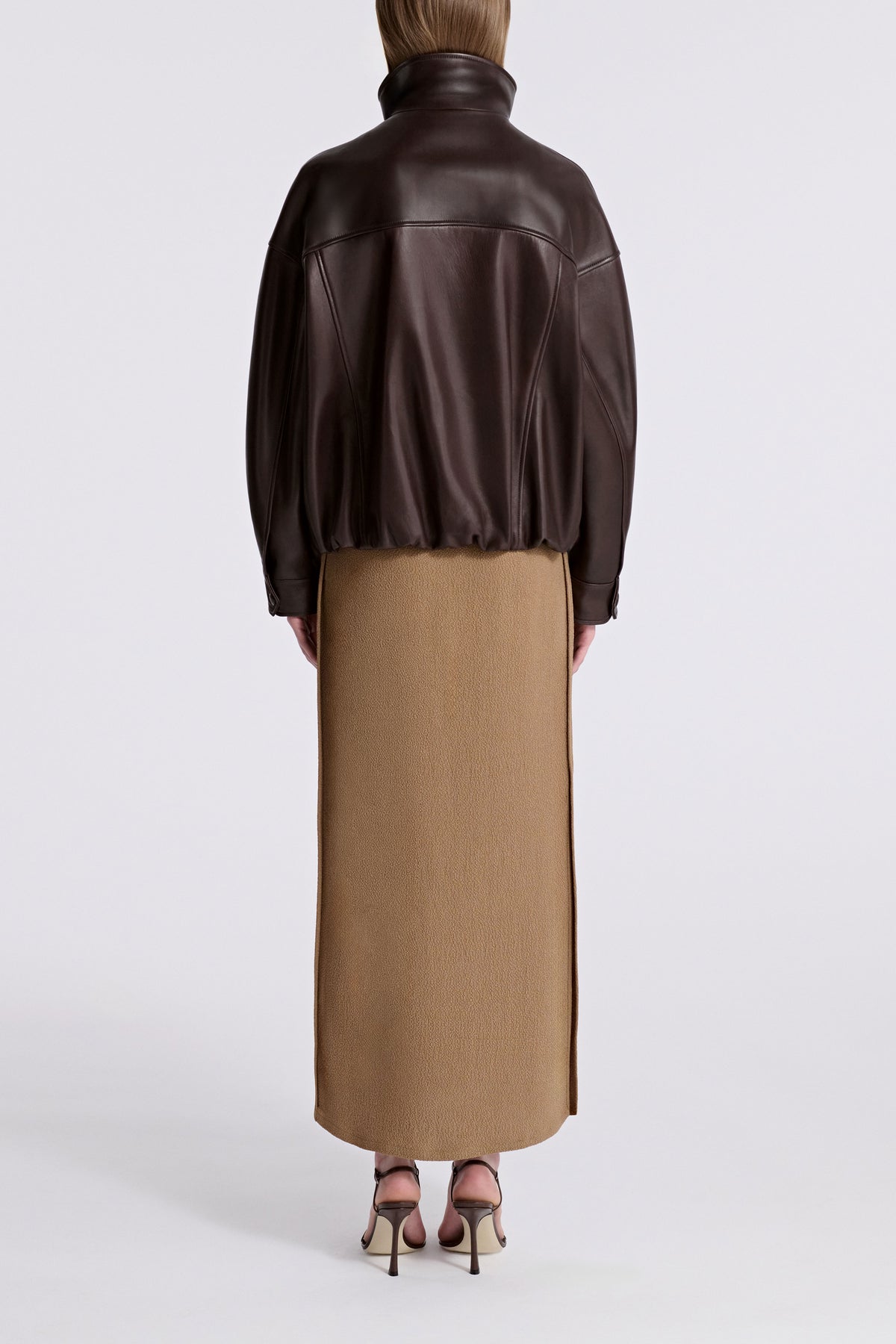 Model is Wearing Nour Hammour Roland Funnel Neck Leather Bomber Ebony Brown - Back