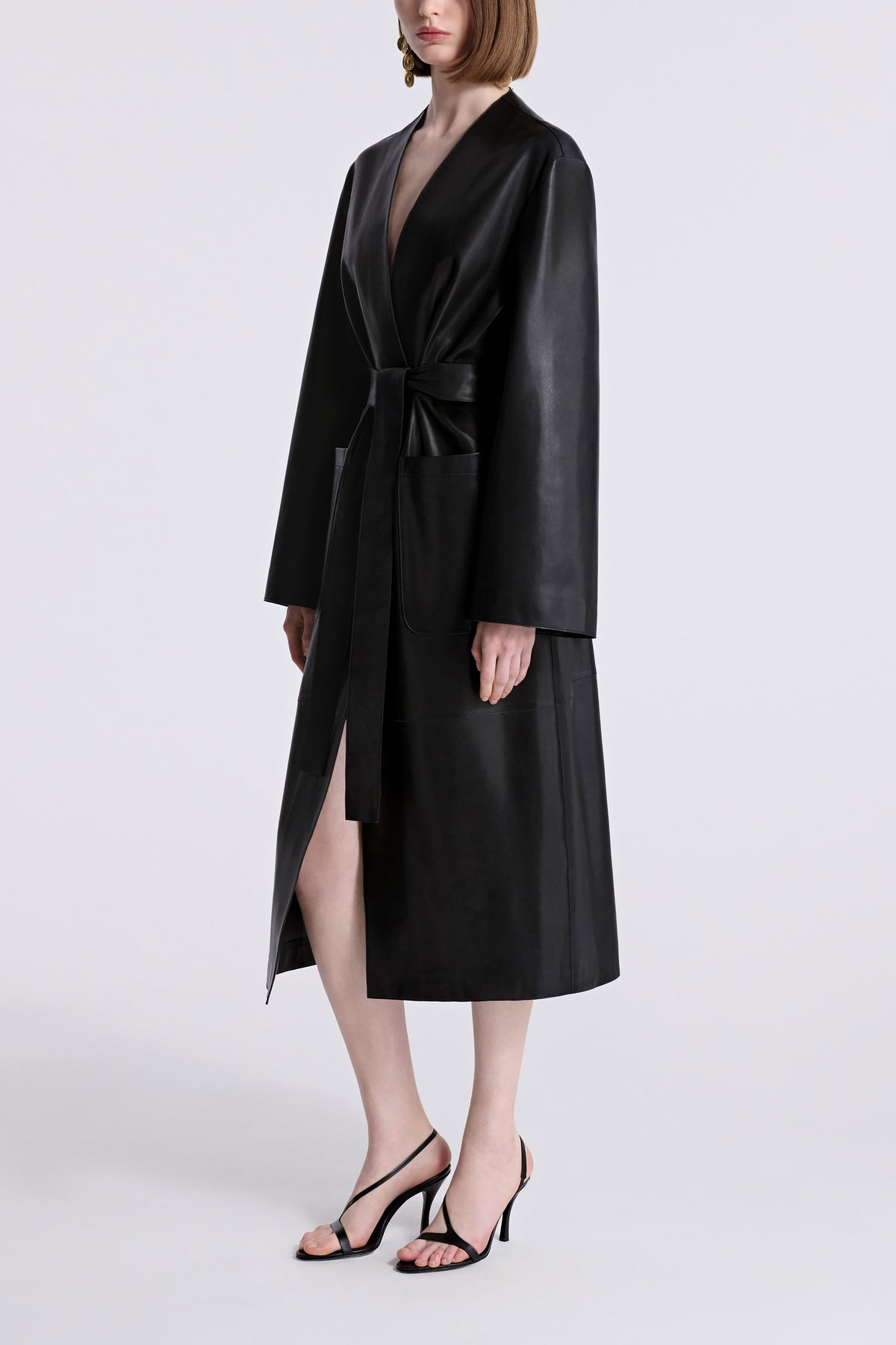 Model is Wearing Nour Hammour Ruelle Collarless Leather Trench Noir Classique - Three Quarters