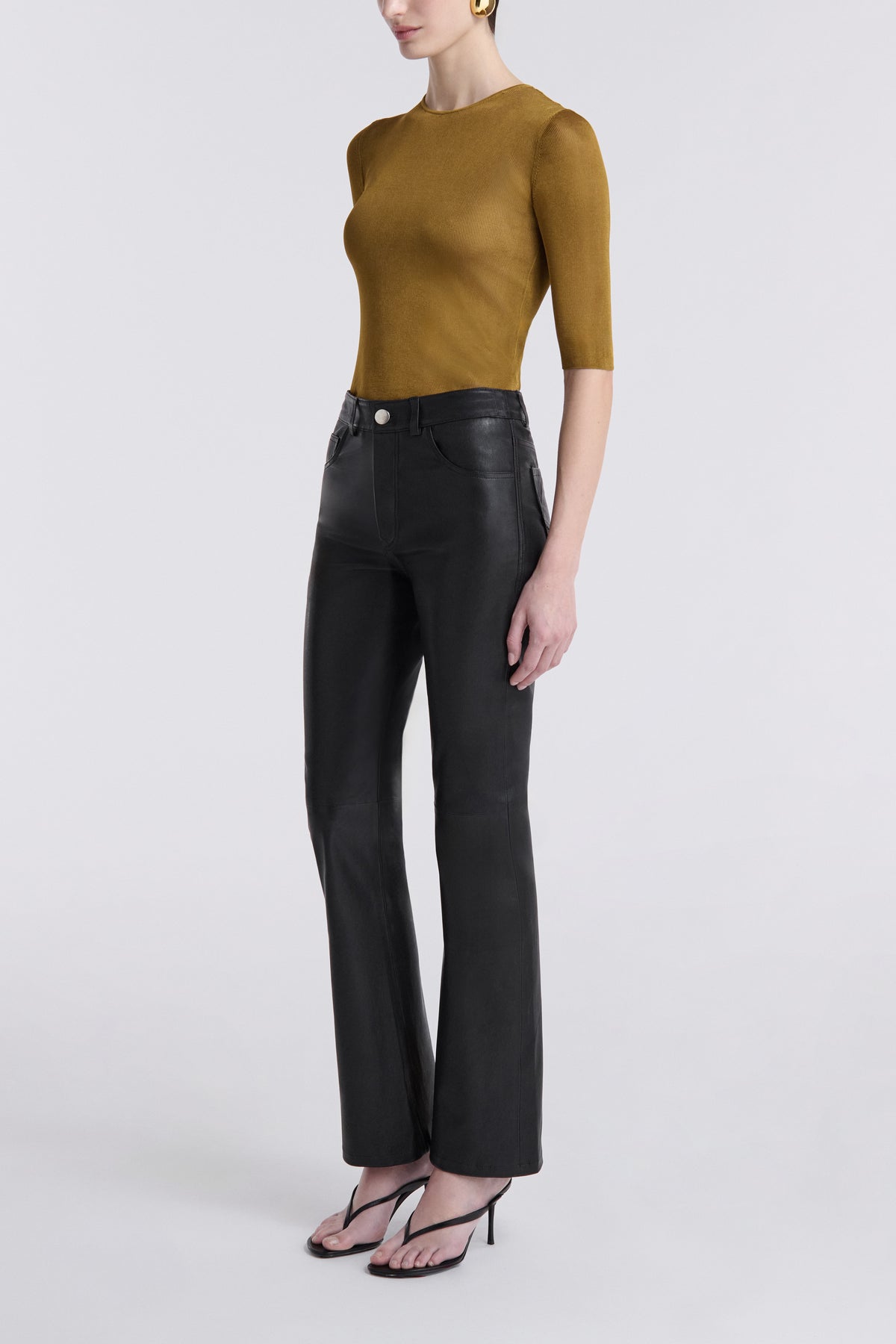Model is Wearing the Nour Hammour Flare Stretch Leather Pants Black - Three Quarters