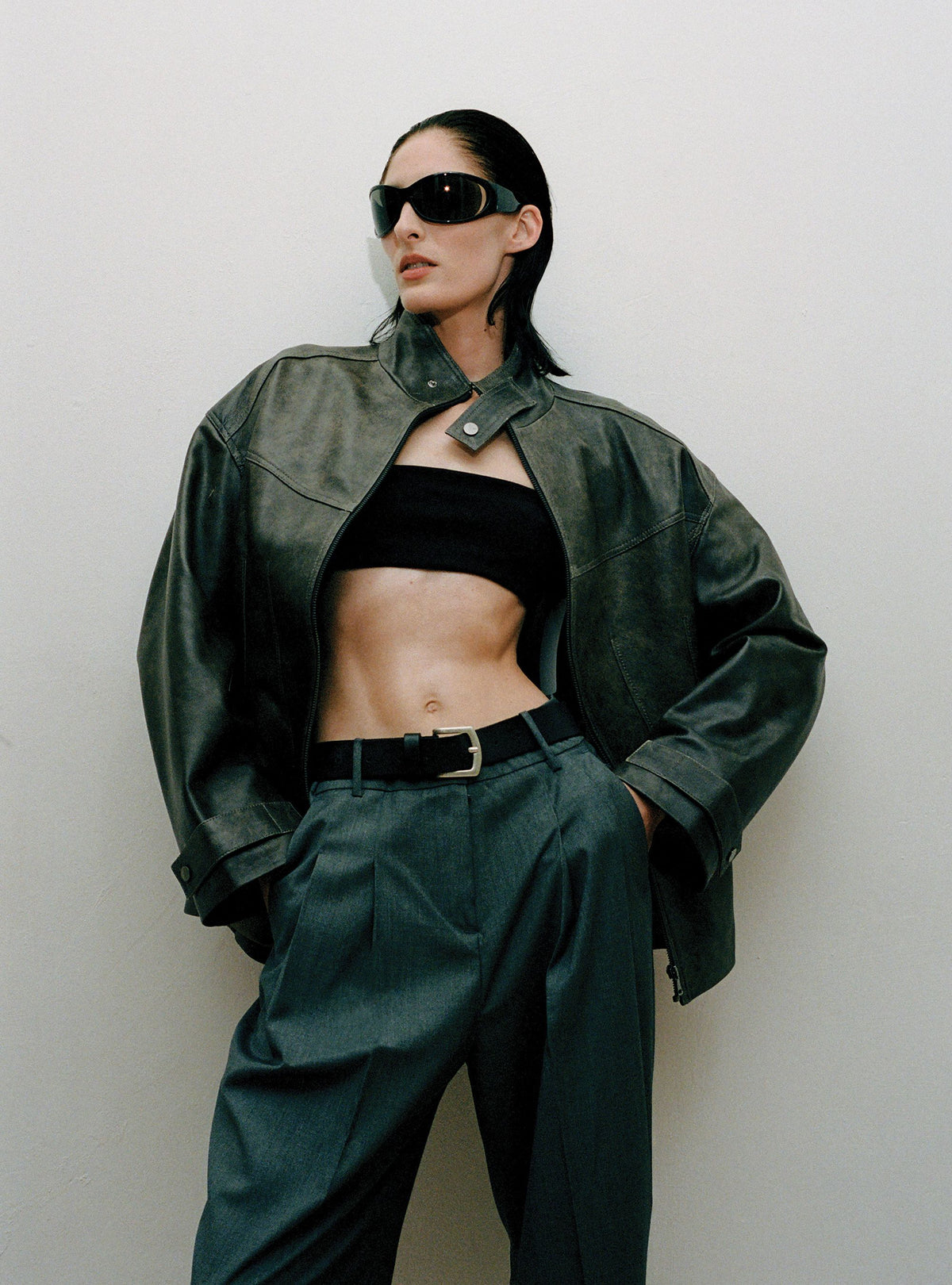 A model standing wearing the Rue Dark Marble leather jacket